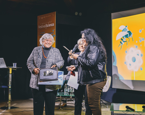 La consegna della targa a Maria Del Zompo. A destra, l'artista Maria Conte (Foto Cam&ugrave;)